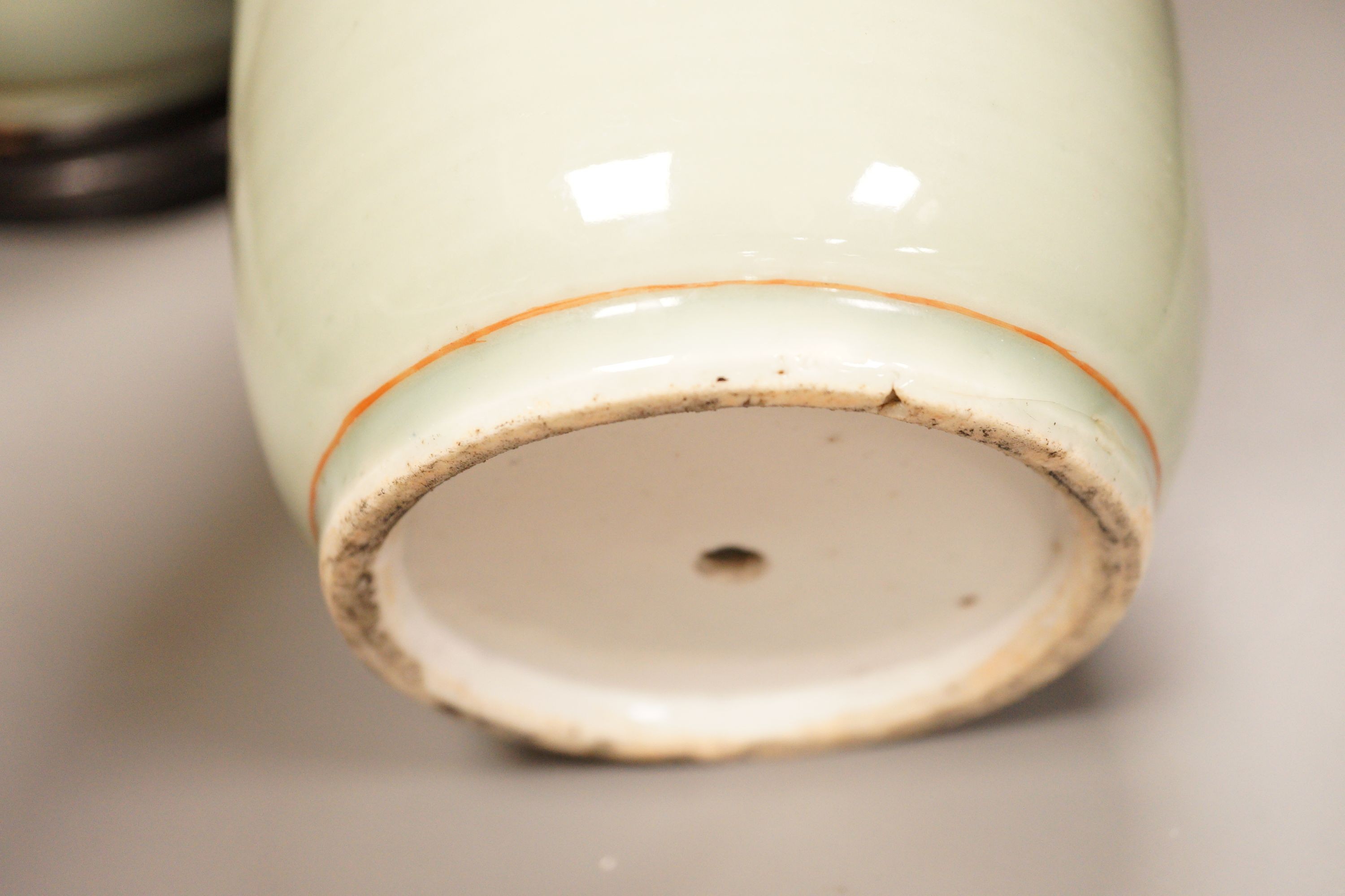 A pair of 19th century Japanese celadon glazed vases (drilled) with hardwood stands, total height 31cm
